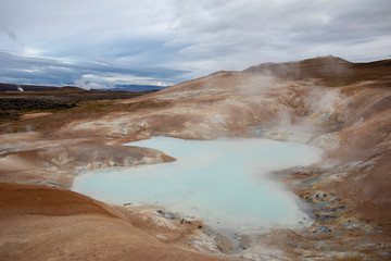 Fototapeta premium Geothermal fields Iceland Europe. Geysers and fumaroles emit white cloud of steam