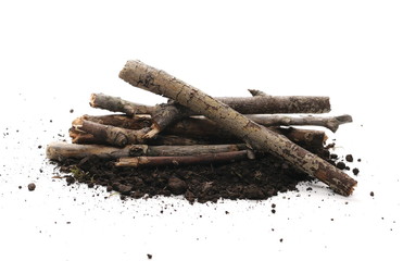 Soil, dirt pile with twigs, branches isolated on white background