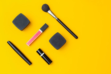 Beauty products on yellow background. Copy space