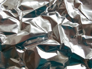 abstract background. Crumpled foil, silver.