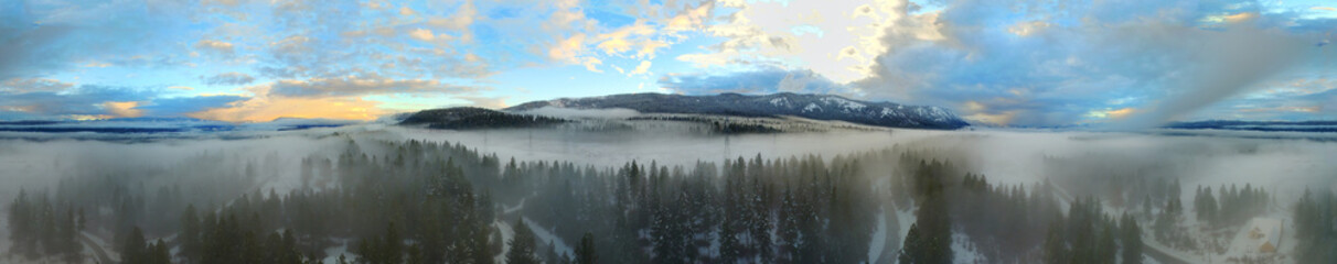 Fototapeta premium Amazing wide photo from drone above cloud with fog in the forest and sunset and clear sky above. Mountains. Cle Elum, WA state. USA