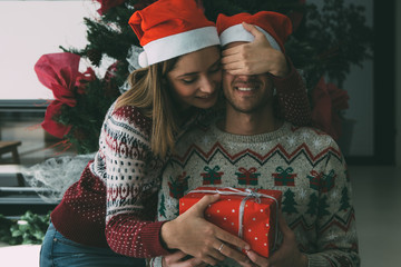 Young man receive Christmas gift from woman