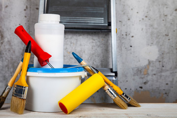 Paint can and brush on the table.