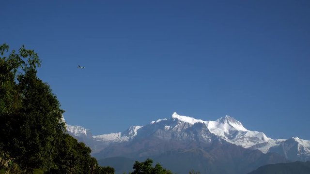 Small Airplane Flying Over Himalayan Mountain Range