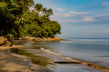 Beautiful seascape. Sea, mountains, sky, sunset and palm trees. Beautiful places of the island of Phuket, Thailand.