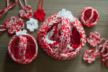 Martenitsa, white and red strains of yarn, Bulgarian folklore tradition, welcoming the spring in March, symbol, wish for good health. Crochet basket and flowers pendants. Baba Marta Day.