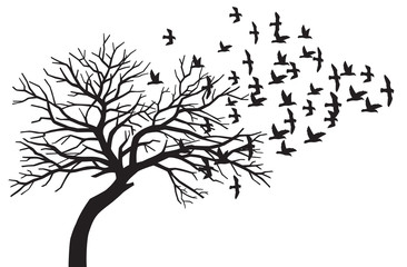 scary bare black tree silhouette and flock of flying birds