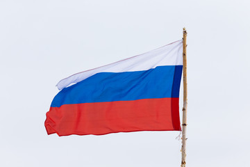 Flag of different Russian Federation on the background of the gloomy sky