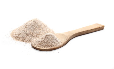Pile of integral wheat flour with wooden spoon isolated on white