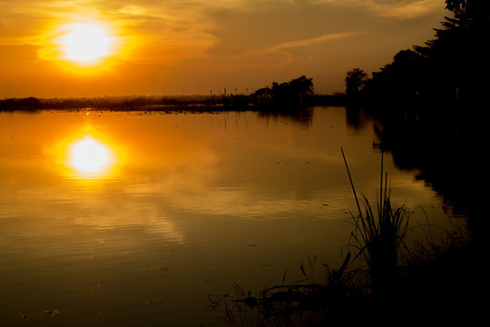 Silhouette shot,  Sunset Over lake or pond or swamp of Bueng See Fai, Phichit, Thailand