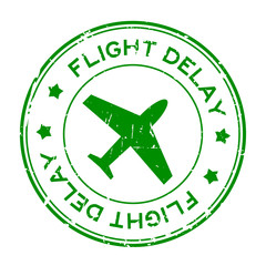 Grunge green flight delay word with airplane icon round rubber seal stamp on white background