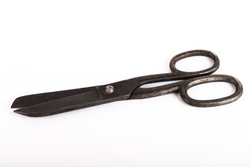 Old metal scissors on a light background