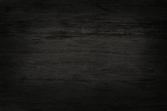 Black wooden wall background, texture of dark bark wood with old natural pattern for design art work, top view of grain timber.