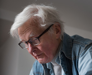 Elderly man with glasses.