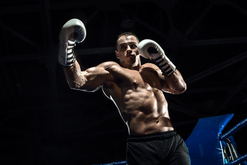 Fototapeta na wymiar punching boxer on boxing ring