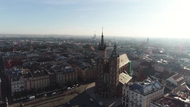 Old city center view with Adam Mickiewicz monument and St. Mary's Basilica in Krakow on the morning, aerial