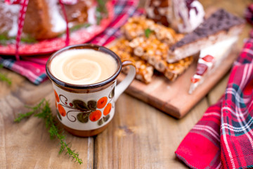 Christmas bread for a festive breakfast. on a wooden background and traditional festive winter sweets. Morning drink and nuts in caramel. Photo tinted. Top view.