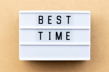 Light box with word best time on wood background
