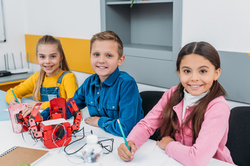 happy pupils making robot during STEM robotics lesson