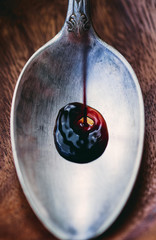 Italian wine balsamic vinegar is poured into a spoon closeup macro