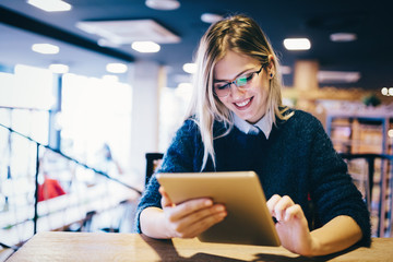 Portrait of young attractive woman using tablet