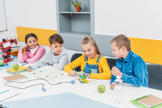 happy children working together on STEM project in classrom
