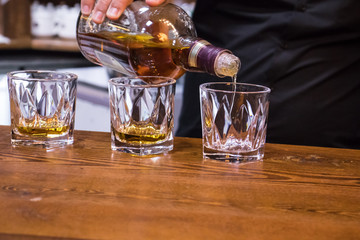 barman pouring whisky