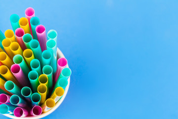 Colorful straws for beverage soft drink on colored background