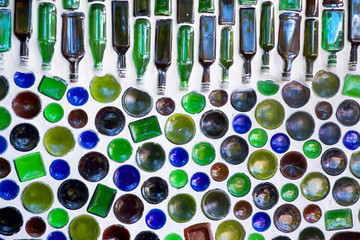 one hundred glass bottles used as sustainable building materials the Glass Bottles are built into a white wall