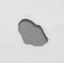 torn white paper on gray paper background, copy space.