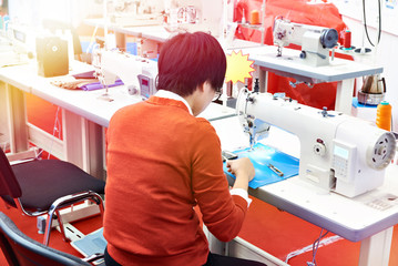 Worker and sewing machine in workshop
