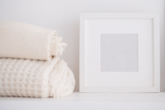 Picture frame and throws on a shelf
