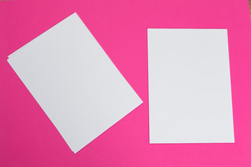 Obraz na płótnie Canvas mock up concept. cards Papers on pink background. Top view, flat lay, copy space