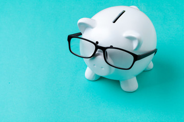 Pink piggy bank with glasses © NewFabrika
