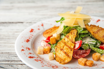Caesar salad on a white plate close up