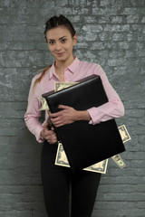 satisfied secretary holds a briefcase stuffed with money