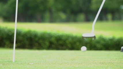 Business guy playing golf.