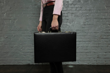 secretary is holding a briefcase