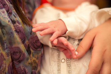 The sacrament of baptism, the rite of baptism. Baby feet and handles