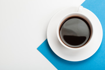 Top view of a coffee cup on a blue and white background