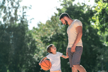 Fototapeta premium Young family with a ball