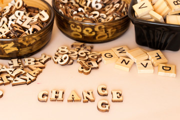 Wooden letters on a pink background. The replacement of one character changes the meaning of the word CHANCE to CHANGE. The replacement of one character