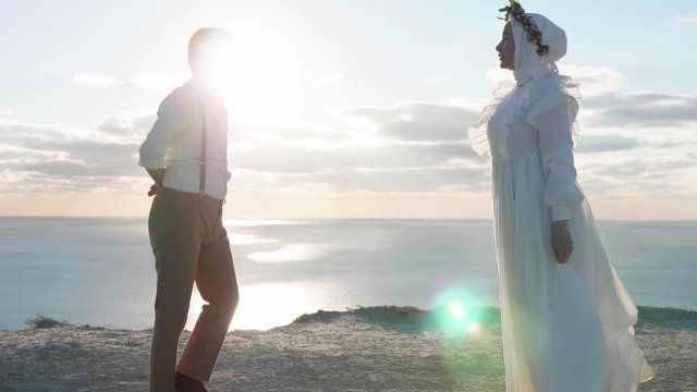 Young pretty asian couple dancing on the hight cliff in slow motion