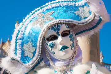 Person wearing venitian carnival mask during Venice carnival in Italy