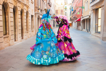 Fototapeta na wymiar Girls wearing venitian carnival mask during Venice carnival in Italy