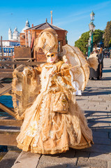 Fototapeta na wymiar Person wearing venitian carnival mask during Venice carnival in Italy