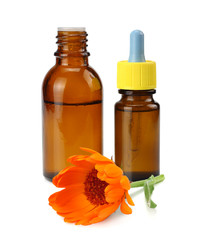 bottle with marigold oil with marigold flowers isolated on white background. calendula flower.