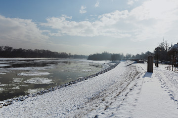 Sidewalk and river dam covered with slush and snow in Szentendre, Hungary
