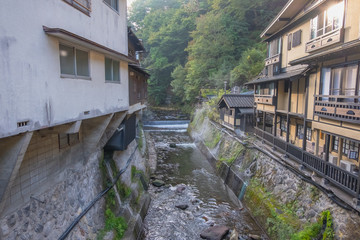 Fototapeta na wymiar Hot spring towns, Kurokawa Onsen, Ryokan and bridge, Kurokawa at morning, Kumamoto, Kyushu, Japan
