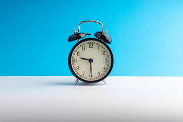Clock on colorful background with selective focus and crop fragment. Copy space concept